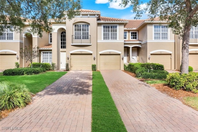 18911 Bay Woods Lake Dr Unit 102, Fort Myers, FL 33908 - view of front of home with a tiled roof, driveway, stucco siding, and a garage