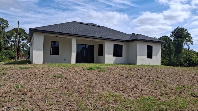 3501 70th St W, Lehigh Acres, FL 33971 - back of house with a ceiling fan, a shingled roof, and stucco siding