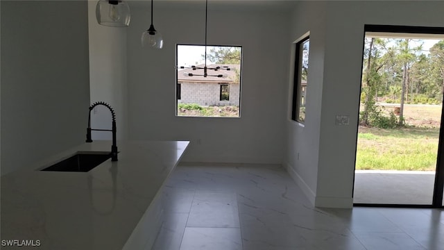 3501 70th St W, Lehigh Acres, FL 33971 - unfurnished dining area featuring a sink, baseboards, and marble finish floor