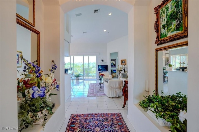 281 Lenell Rd Unit 1 7-A, Fort Myers Beach, FL 33931 - hall featuring recessed lighting, light tile patterned flooring, visible vents, a towering ceiling, and arched walkways