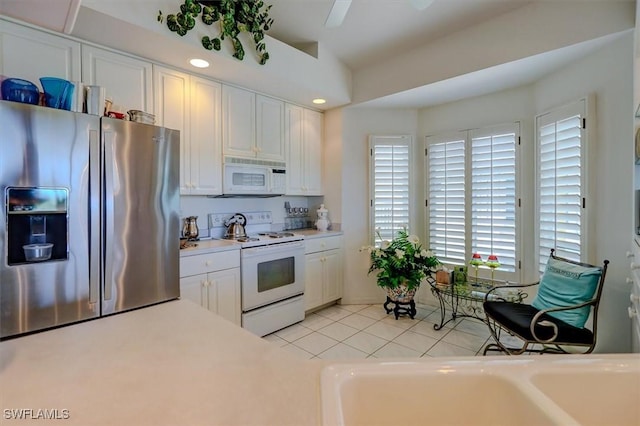 281 Lenell Rd Unit 1 7-A, Fort Myers Beach, FL 33931 - kitchen with light tile patterned floors, white appliances, a ceiling fan, white cabinetry, and light countertops