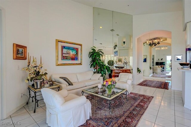 281 Lenell Rd Unit 1 7-A, Fort Myers Beach, FL 33931 - living room with light tile patterned floors, arched walkways, high vaulted ceiling, and an inviting chandelier