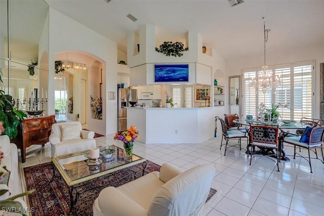 281 Lenell Rd Unit 1 7-A, Fort Myers Beach, FL 33931 - living area featuring light tile patterned floors, arched walkways, a notable chandelier, and high vaulted ceiling