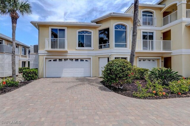 281 Lenell Rd Unit 1 7-A, Fort Myers Beach, FL 33931 - multi unit property featuring decorative driveway, a garage, and stucco siding