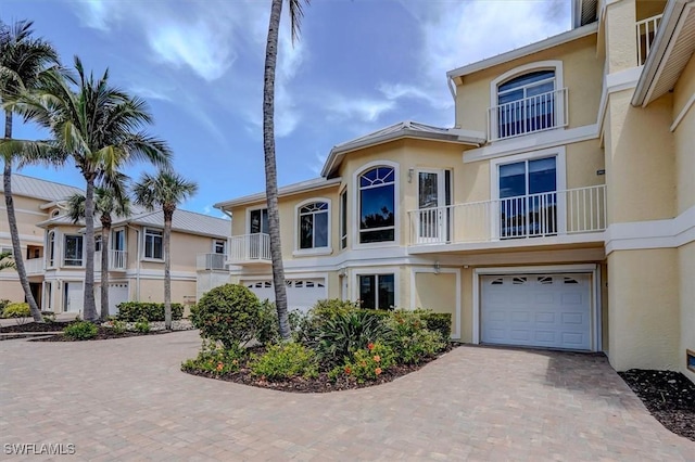 281 Lenell Rd Unit 1 7-A, Fort Myers Beach, FL 33931 - view of front of house with stucco siding, decorative driveway, and a garage