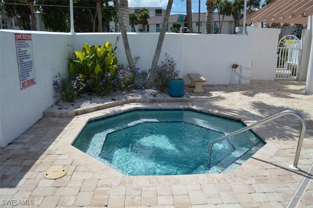 281 Lenell Rd Unit 1 7-A, Fort Myers Beach, FL 33931 - view of swimming pool featuring a patio, fence, a community hot tub, and a pergola