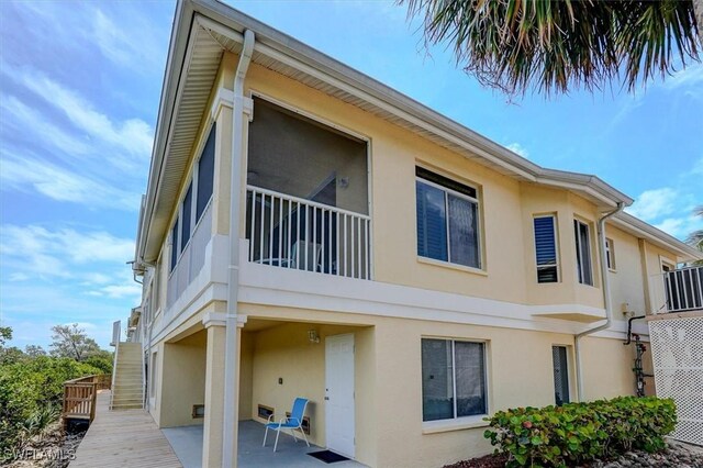 281 Lenell Rd Unit 1 7-A, Fort Myers Beach, FL 33931 - view of side of home featuring stucco siding and a patio area