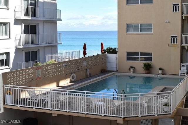 view of swimming pool featuring a water view