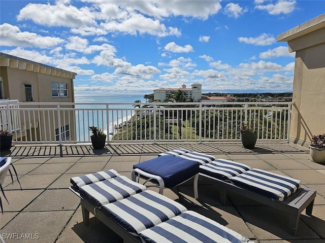 view of patio / terrace with a balcony and a water view