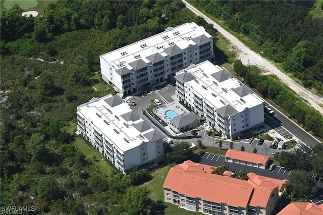 birds eye view of property with a view of trees