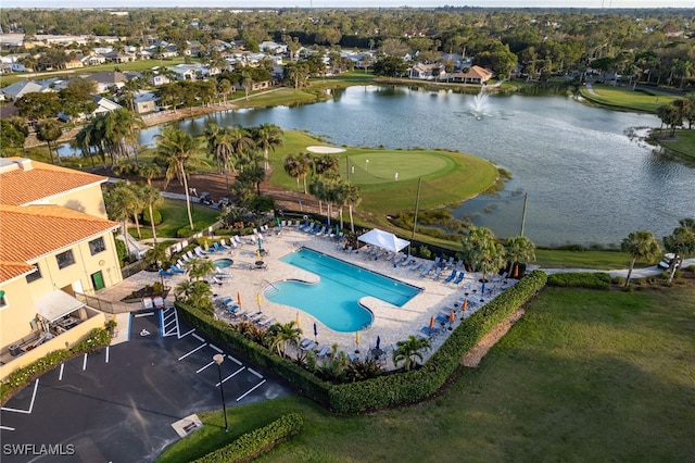 birds eye view of property with golf course view and a water view