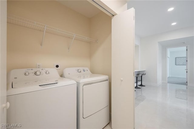 washroom featuring recessed lighting, laundry area, light tile patterned floors, baseboards, and separate washer and dryer
