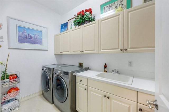 8993 Crooked Stick Ct, Naples, FL 34113 - laundry room featuring baseboards, washing machine and clothes dryer, a sink, cabinet space, and light tile patterned floors