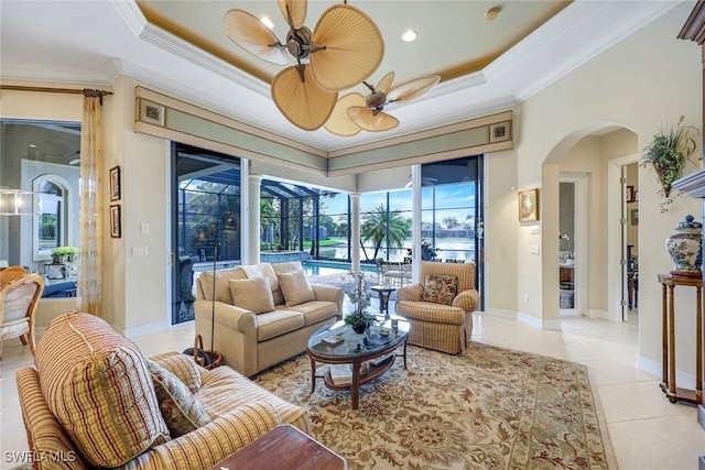 8993 Crooked Stick Ct, Naples, FL 34113 - living area with ceiling fan, a sunroom, a raised ceiling, arched walkways, and light tile patterned floors