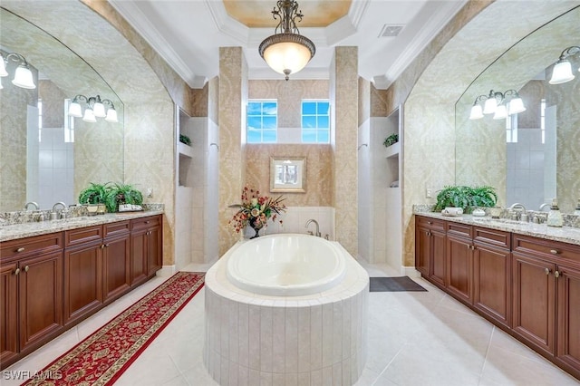 8993 Crooked Stick Ct, Naples, FL 34113 - bathroom featuring a garden tub, two vanities, and tile walls