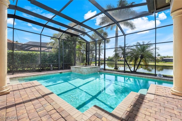 8993 Crooked Stick Ct, Naples, FL 34113 - view of pool featuring glass enclosure, a water view, a pool with connected hot tub, and a patio area