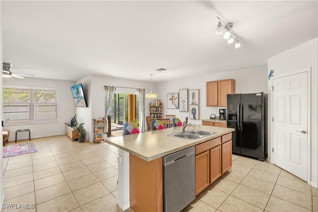 618 SW 18th St, Cape Coral, FL 33991 - kitchen featuring light tile patterned floors, stainless steel dishwasher, a sink, plenty of natural light, and black fridge