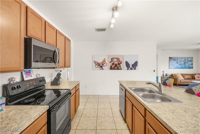 618 SW 18th St, Cape Coral, FL 33991 - kitchen featuring appliances with stainless steel finishes, light countertops, brown cabinets, a sink, and visible vents
