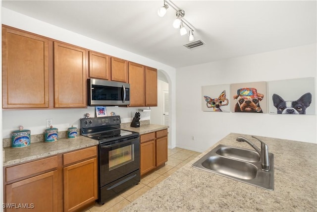 618 SW 18th St, Cape Coral, FL 33991 - kitchen featuring stainless steel microwave, light tile patterned floors, electric range, light countertops, and a sink