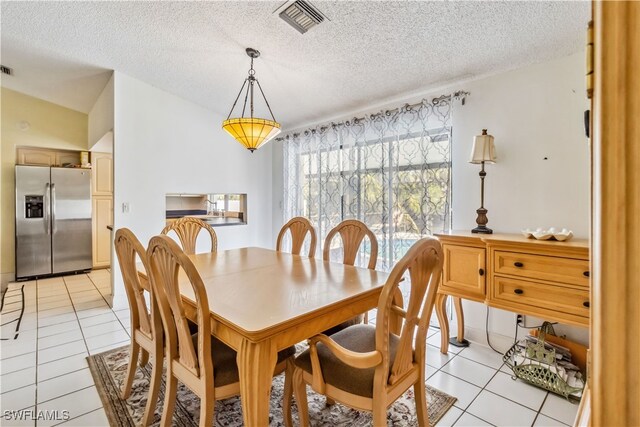 4736 25th Ave SW, Naples, FL 34116 - dining area with light tile patterned flooring, a textured ceiling, and visible vents
