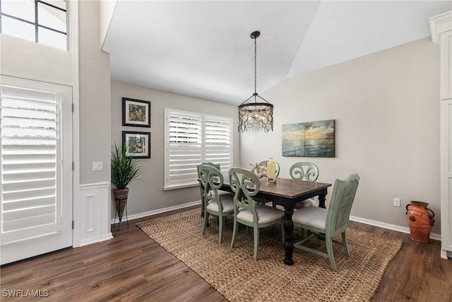 dining room featuring baseboards, dark wood-style flooring, a notable chandelier, and lofted ceiling