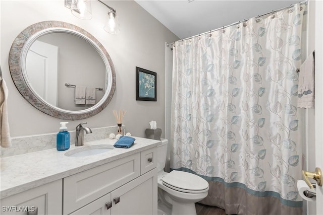 full bath featuring vanity, curtained shower, and toilet