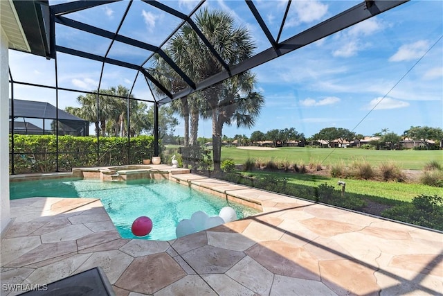 view of pool with a patio area, a yard, glass enclosure, and a pool with connected hot tub