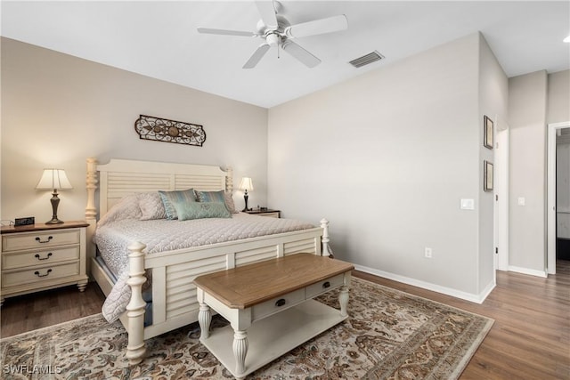 bedroom with wood finished floors, visible vents, baseboards, and ceiling fan