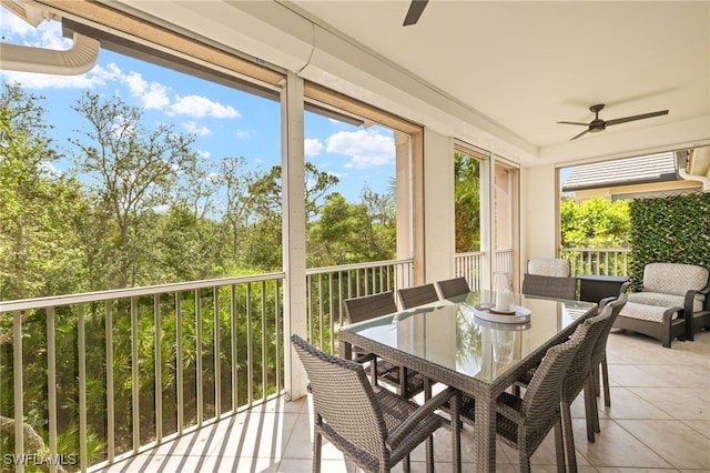 sunroom with outdoor dining space and ceiling fan
