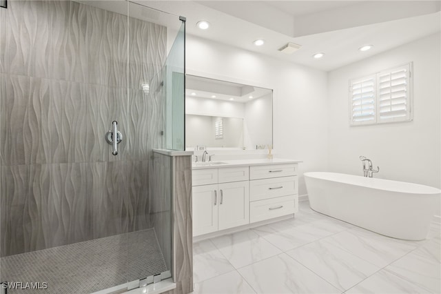 full bath with recessed lighting, a soaking tub, marble finish floor, and vanity