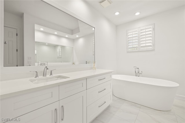 bathroom with visible vents, recessed lighting, marble finish floor, and a soaking tub