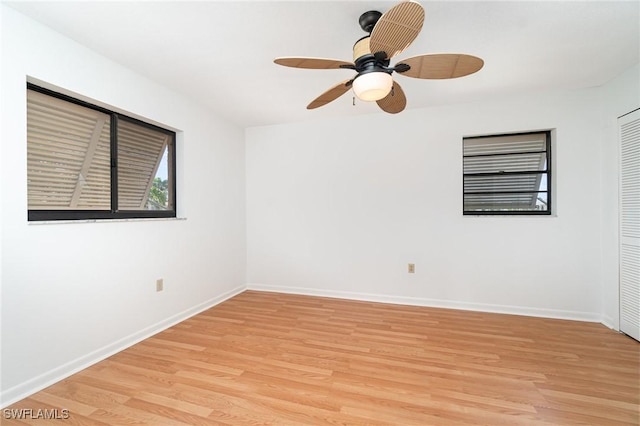 unfurnished room with baseboards, a ceiling fan, and light wood-style floors