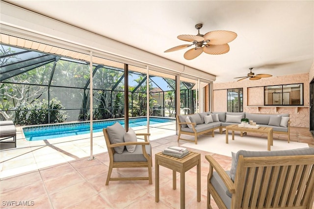 sunroom / solarium with ceiling fan, a pool, and an outdoor hangout area