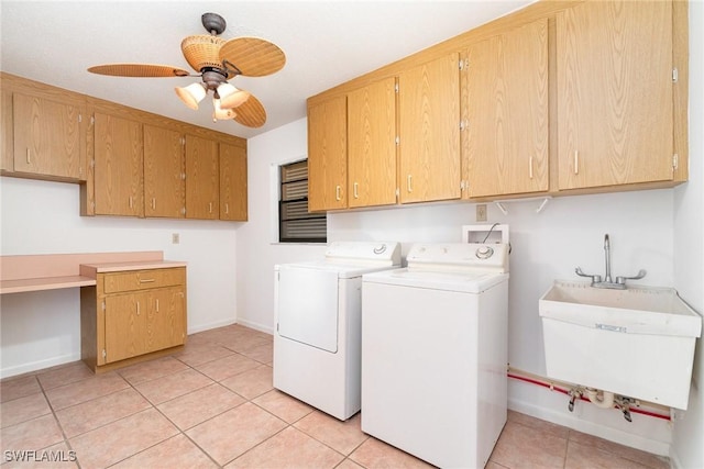 washroom with a sink, washer and clothes dryer, light tile patterned flooring, ceiling fan, and cabinet space