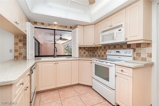 kitchen with light countertops, a ceiling fan, a sink, white appliances, and tasteful backsplash