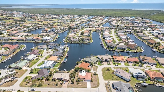drone / aerial view featuring a residential view and a water view