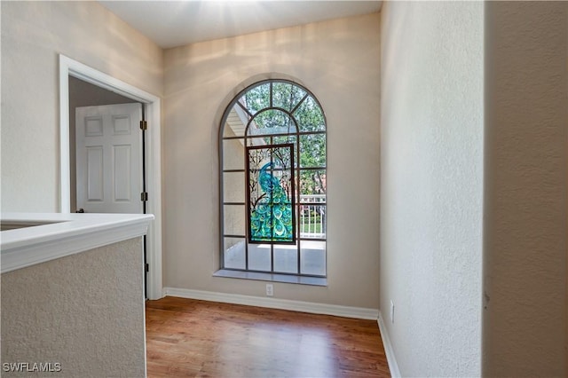 interior space featuring baseboards and wood finished floors