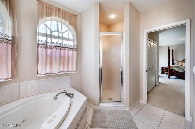full bath with tile patterned flooring, baseboards, ensuite bathroom, a tub with jets, and a shower stall