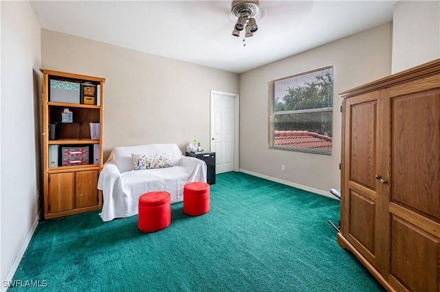 sitting room featuring carpet flooring, baseboards, and ceiling fan
