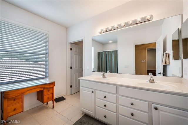 bathroom with a sink, tile patterned floors, and double vanity