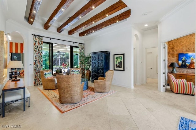 living area with recessed lighting, beam ceiling, baseboards, ornamental molding, and arched walkways
