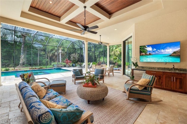 view of patio / terrace with a sink, an outdoor kitchen, glass enclosure, outdoor lounge area, and an outdoor pool