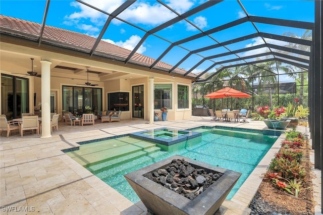 view of pool with an outdoor living space with a fire pit, a patio area, glass enclosure, outdoor dining area, and a pool with connected hot tub