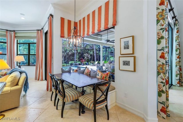 dining area featuring an inviting chandelier, crown molding, and baseboards
