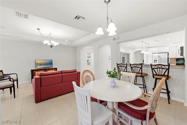9046 Astonia Way, Estero, FL 33967 - dining room with a chandelier, arched walkways, and visible vents