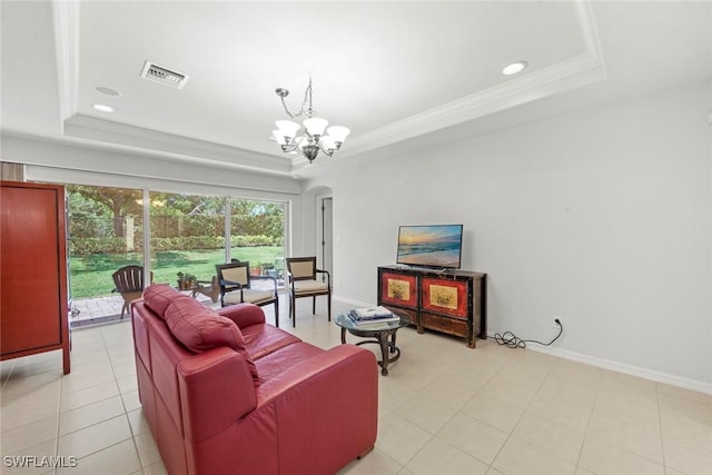 9046 Astonia Way, Estero, FL 33967 - living room with arched walkways, an inviting chandelier, a tray ceiling, baseboards, and visible vents