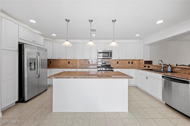 9046 Astonia Way, Estero, FL 33967 - kitchen with a center island, a sink, light tile patterned flooring, stainless steel appliances, and white cabinets