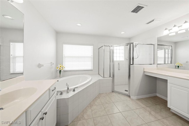 9046 Astonia Way, Estero, FL 33967 - bathroom featuring tile patterned floors, visible vents, a bath, two vanities, and a stall shower