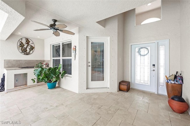 9046 Astonia Way, Estero, FL 33967 - entrance foyer featuring a wealth of natural light, a ceiling fan, and a textured ceiling