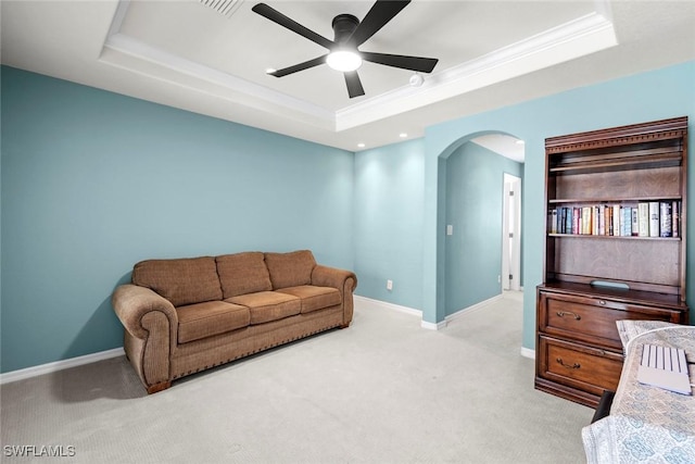 9046 Astonia Way, Estero, FL 33967 - living area featuring carpet flooring, arched walkways, baseboards, a ceiling fan, and a raised ceiling